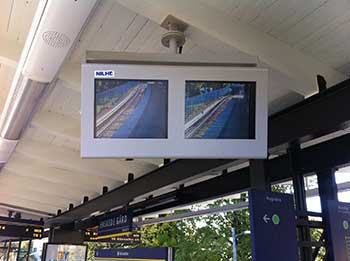 Custom built dual, side-by-side monitor enclosure on a train platform