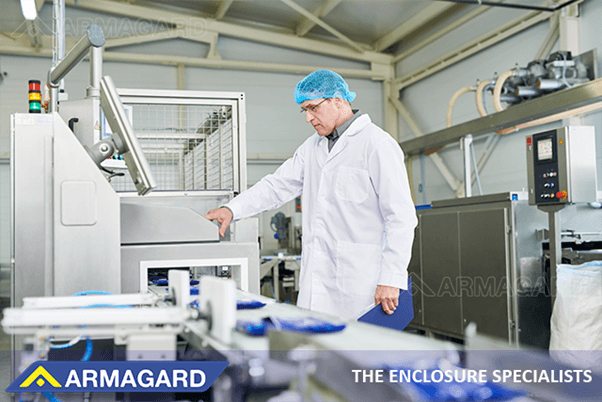 An operator working with a food manufacturing digital display.