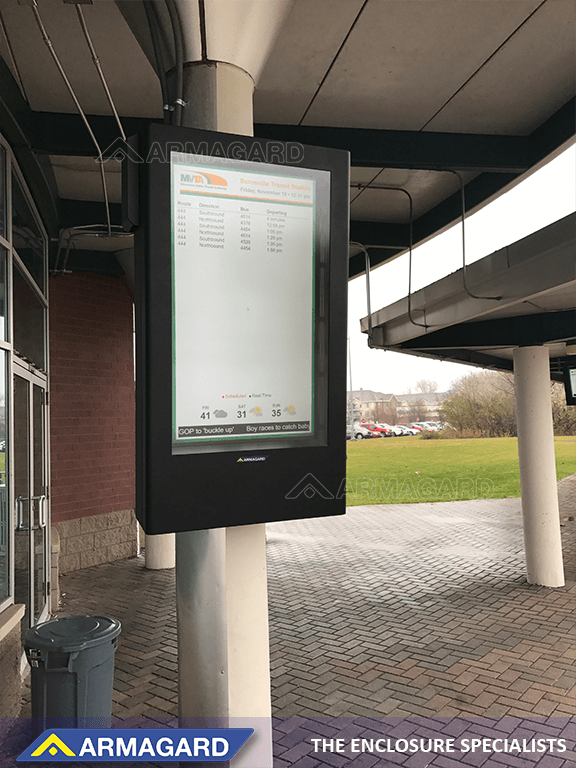 Portrait TV enclosure displaying a travel timetable at a bus station