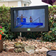 An Outdoor TV Enclosure 55 Inch on Stand in Backyard