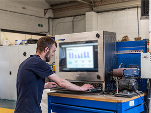 An industrial worker using a PC HMI enclosure