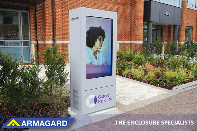 Freestanding portrait enclosure protecting an outdoor TV screen for schools