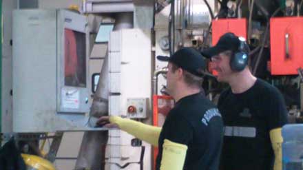 shop floor workers using a computer housed in an Armagard industrial computer enclosure