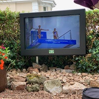 An outdoor TV cabinet in an external seating area