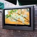 Article about outdoor TV enclosures vs. outdoor TVs Armagard outdoor tv enclosure mounted on a patio wall